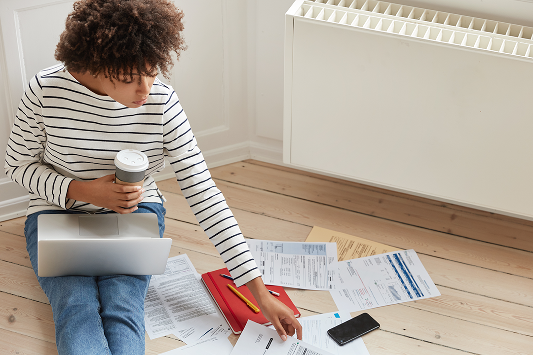 energy-efficiency-heating-service heating systems energy efficiency women on floor looking at bills