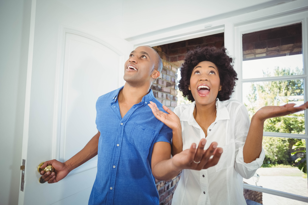 happy-couple-entering-their-house-cheering clean air in happy couples home